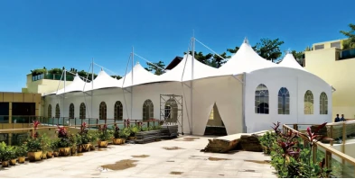 Exterior site photo of the membrane structure project in Sanya, Hainan, showing the completed white canopy building.