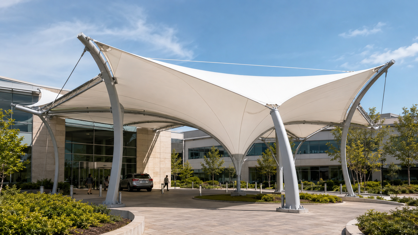 White PVDF tensile membrane canopy for a modern commercial entrance