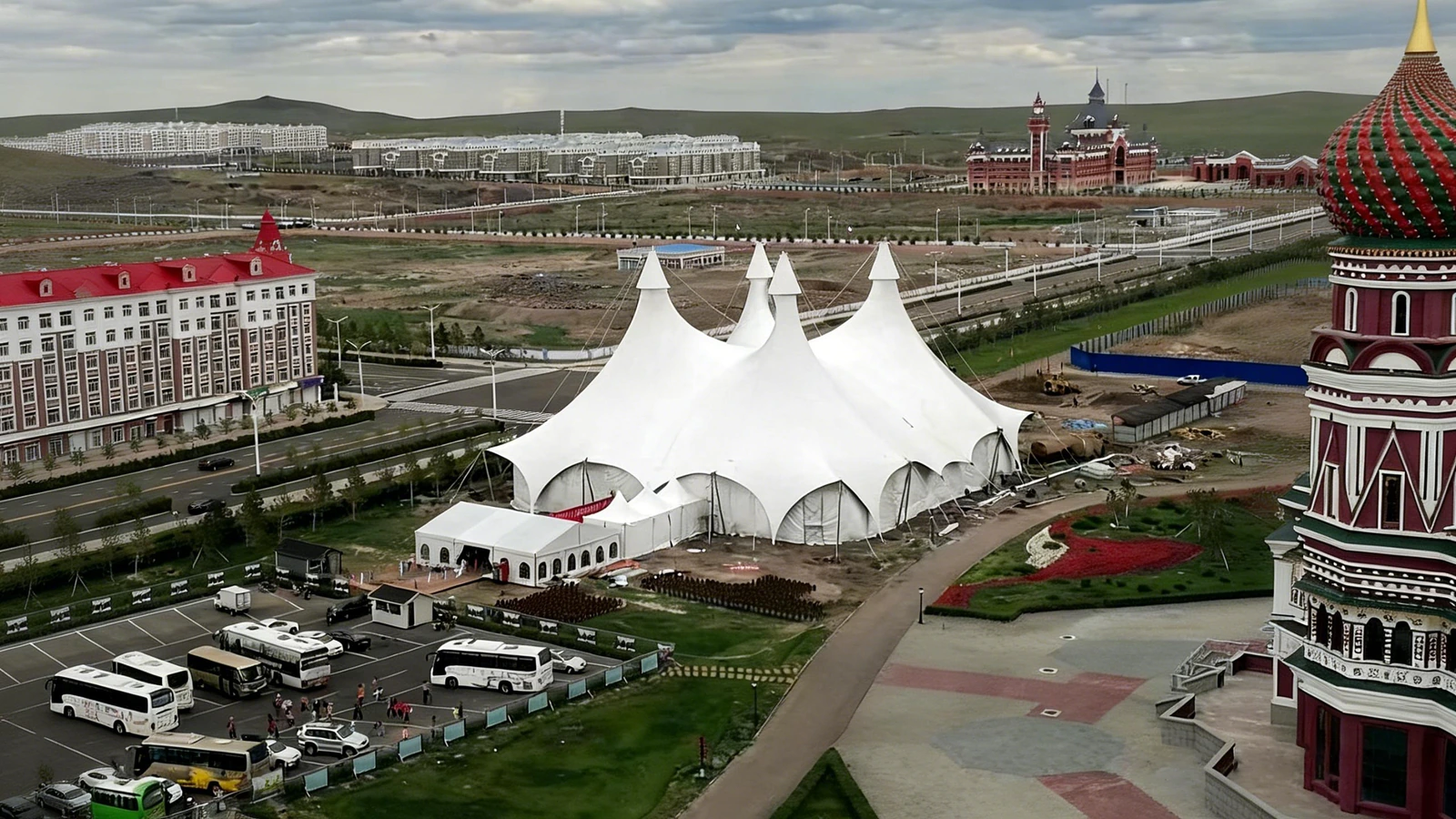 Large white multi-peak circus tent on a site