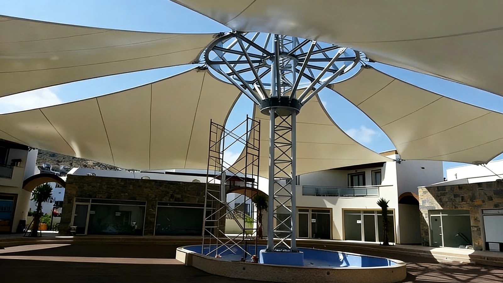 Steel tree structure with a conical membrane canopy at a building entrance