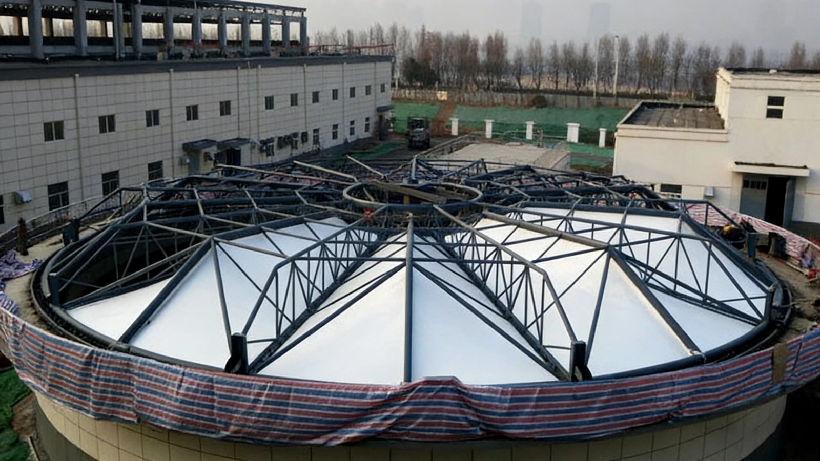 Circular membrane cover over a large treatment tank