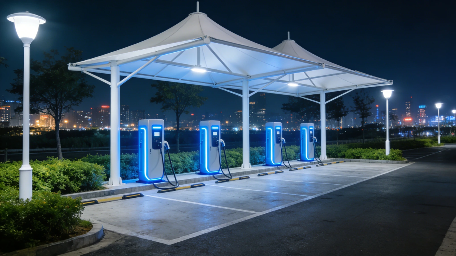 White tensile canopy covering EV charging bays at night