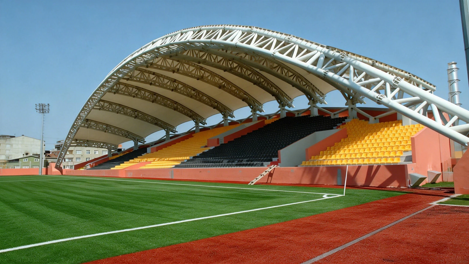 Curved tensile membrane roof over a football grandstand