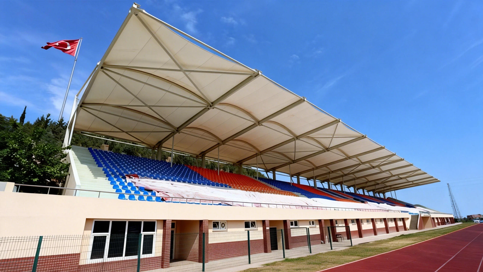 Single-slope membrane canopy over a small sports stand