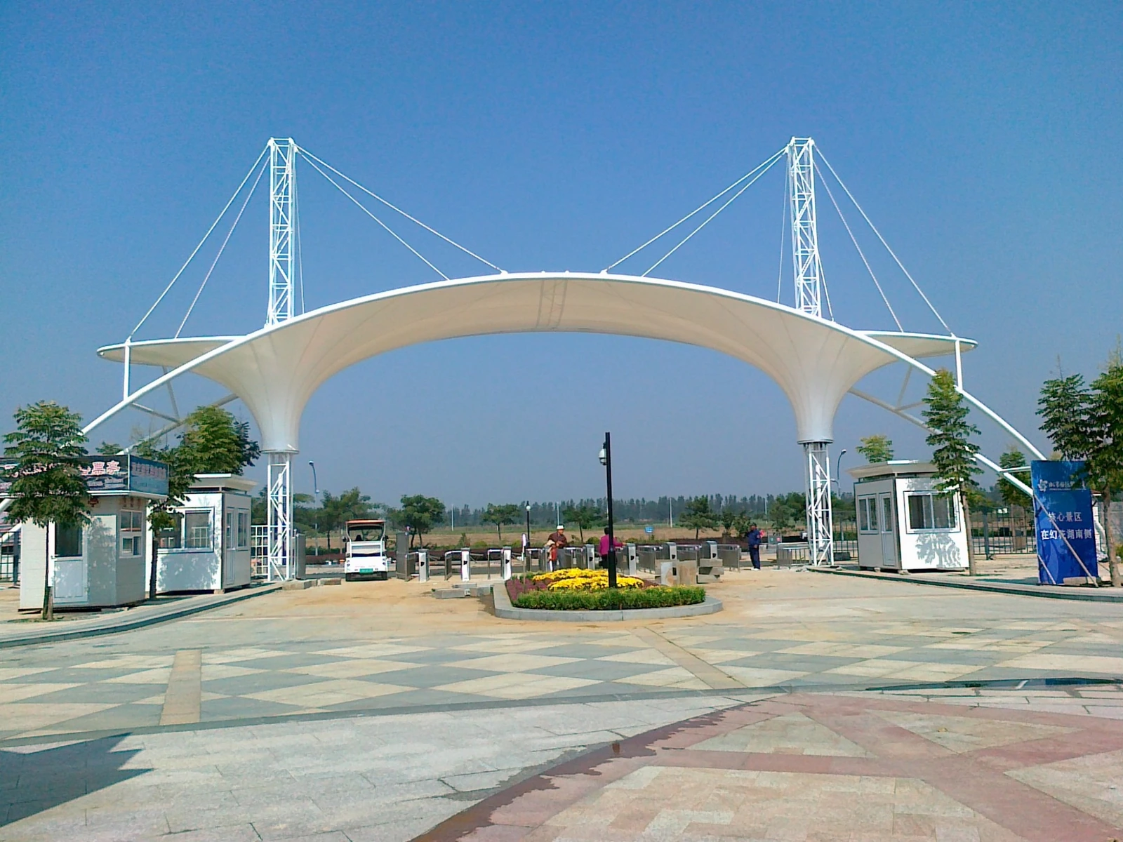 Cable-stayed membrane portal canopy at a highway toll plaza entrance